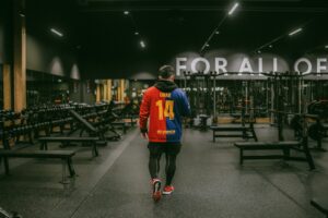 Person walking through gym, symbolizing New Year fitness motivation