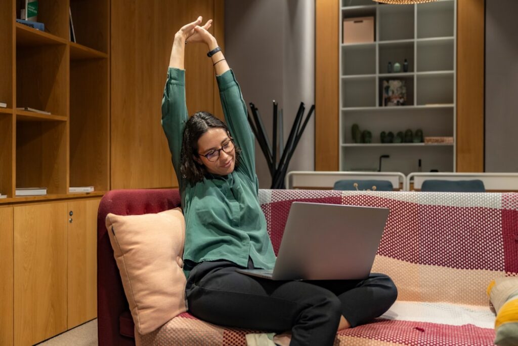 Employee stretching during a work break to support wellness at the office